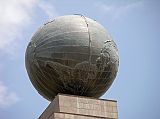 Ecuador Quito 04-03 Mitad Del Mundo Globe Close Up Here is a close up of the globe on top of La Mitad del Mundo. It is 4.5m in diameter, weighs 5 tons, and is encircled by a metal band indicating the Equator Line. The spherical metal globe represents the Earth with its respective relief of the five continents and the oceans.
